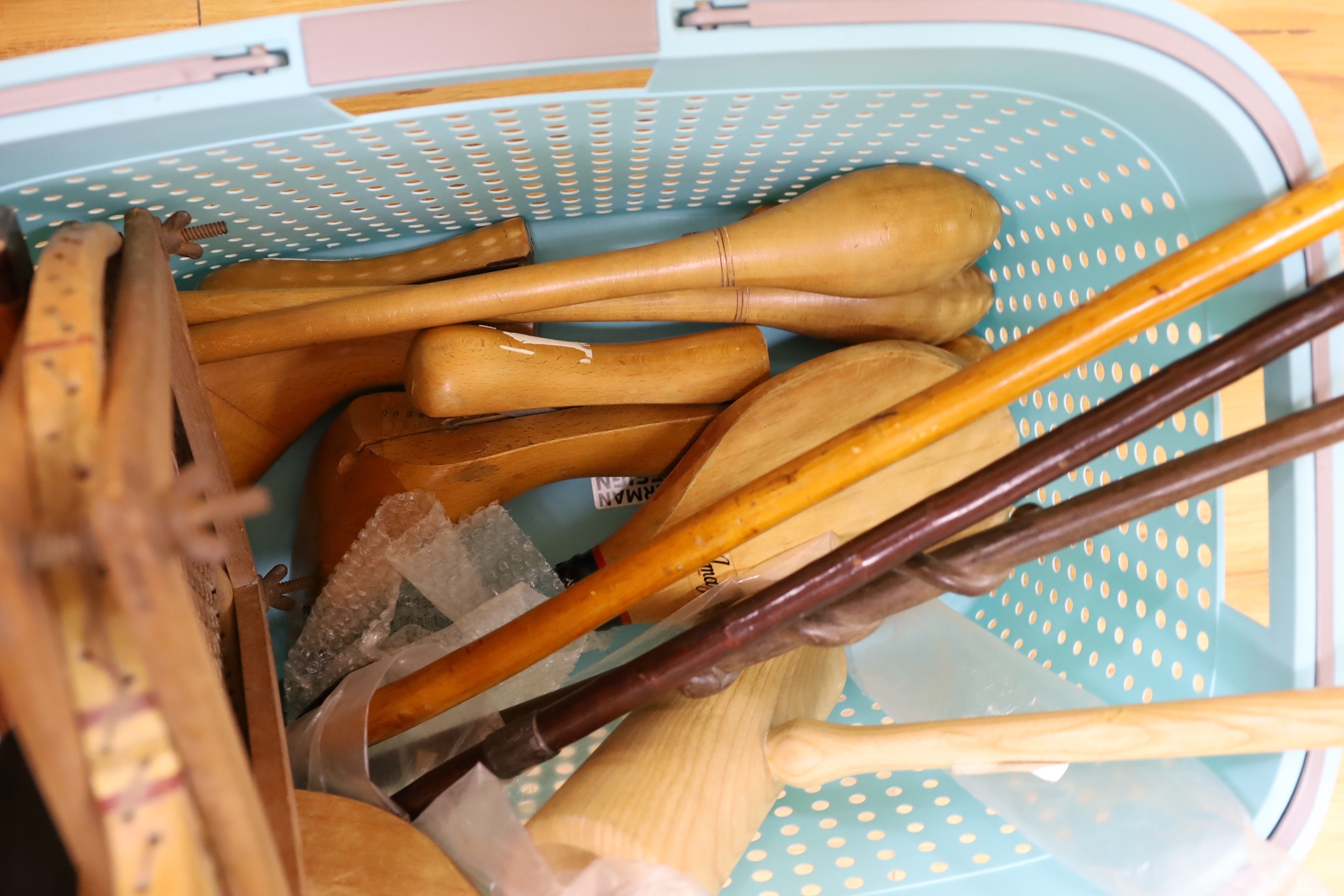 An African walking cane, two walking sticks and vintage sports equipment